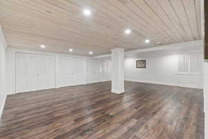 Finished below grade area featuring wooden ceiling, recessed lighting, and dark wood finished floors