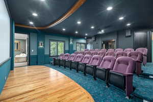 Home theater with recessed lighting, wood finished floors, and carpet floors