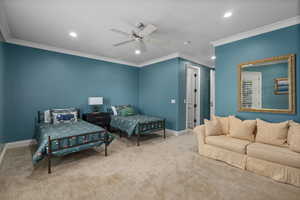 Carpeted bedroom featuring crown molding, recessed lighting, and a ceiling fan