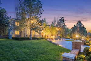 Surrounding community with a lawn and a patio area