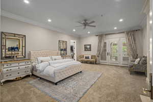 Carpeted bedroom with a spacious closet, crown molding, access to exterior, recessed lighting, and ceiling fan