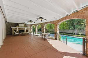 View of patio featuring an outdoor pool and ceiling fan
