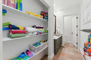 Laundry room with baseboards and recessed lighting