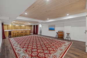 Living area featuring recessed lighting, wooden ceiling, dark wood finished floors, and wet bar