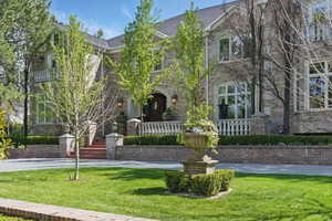View of front of house featuring brick siding and a front yard