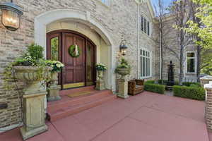View of exterior entry with brick siding