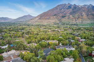 Aerial view of property's location with mountains and nearby suburban area