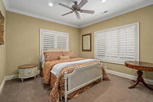 Carpeted bedroom with crown molding, ceiling fan, and recessed lighting