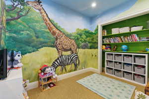 Playroom with baseboards and carpet flooring