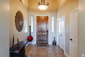 Entrance foyer featuring inlaid floor details and baseboards