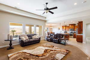 Living room featuring recessed lighting, a chandelier, ceiling fan, and light carpet