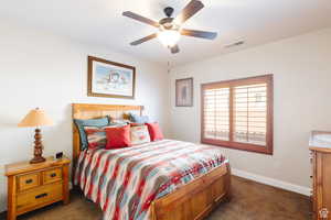 Bedroom featuring dark carpet and ceiling fan