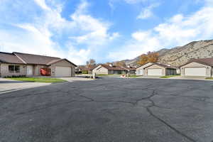 View of asphalt road with a residential view and a mountain view