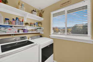 Laundry room with washer and dryer and baseboards