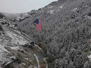 Aerial view of property's location with a mountain backdrop