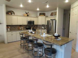 Kitchen featuring updated cabinetry and newer granite countertops and stainless appliances.