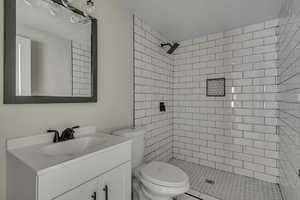 Full bathroom with vanity and a stall shower