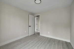 Empty room with baseboards and light wood-style floors