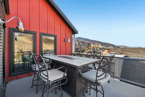 View of patio / terrace with outdoor dining area and a mountain view
