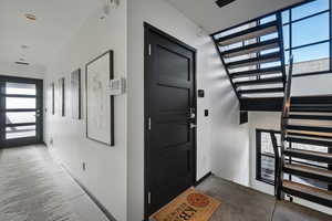 Entrance foyer with healthy amount of natural light and stairs