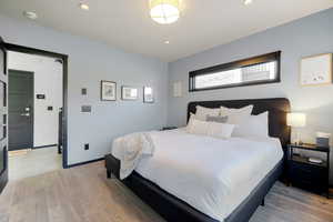 Bedroom with light wood-type flooring and recessed lighting