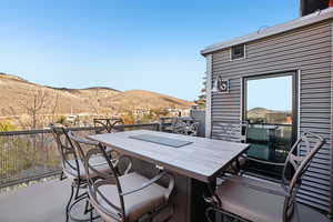 View of patio / terrace featuring a mountain view and outdoor dining area