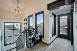 Foyer entrance with light wood-style flooring, plenty of natural light, and lofted ceiling
