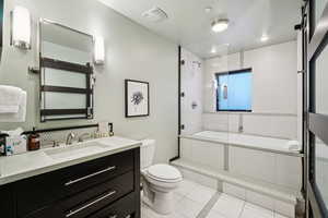 Full bathroom with light tile patterned floors, vanity, and recessed lighting