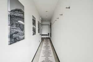 Corridor with baseboards and recessed lighting