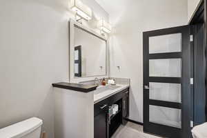 Half bath featuring vanity and decorative backsplash