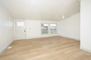 Entryway with healthy amount of natural light, light wood-type flooring, and ceiling fan