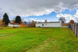 Rear view of property featuring a fenced backyard and a mountain view