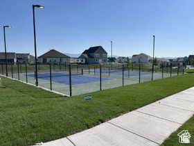 View of tennis court featuring a residential view