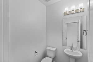 Half bathroom with a sink and toilet