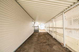 View of side of home with a shed