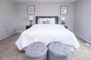 Bedroom with carpet floors and baseboards