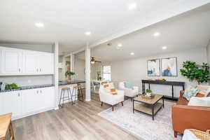 Living area with recessed lighting, ceiling fan, and light wood-type flooring