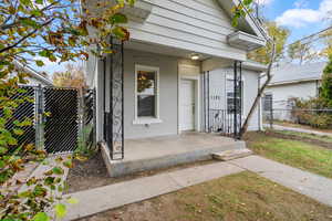 Entrance to property with brick siding and a gate