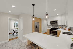 Kitchen featuring bar dining and pendant lighting