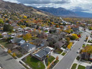 Aerial view of property and surrounding area featuring mountains