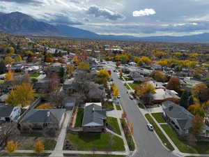 Aerial overview of property's location featuring mountains and nearby suburban area