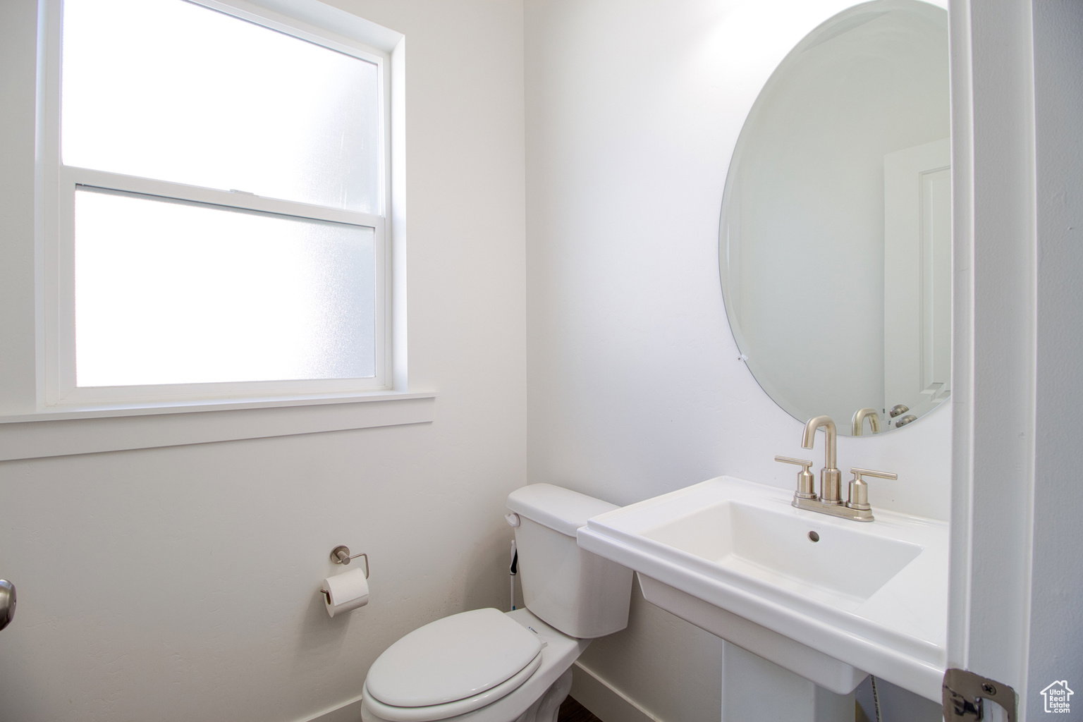 Bathroom featuring toilet and baseboards