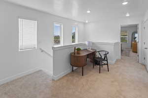 Sitting room featuring light carpet, an upstairs landing, recessed lighting, and a textured ceiling