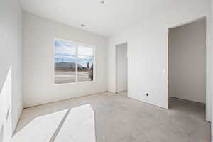 Unfurnished room with a mountain view and unfinished concrete floors