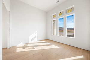 Spare room with light wood-style flooring