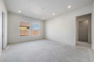 Unfurnished bedroom with recessed lighting and unfinished concrete flooring