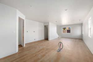 Empty room featuring light wood-type flooring and stairs