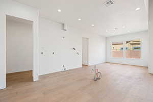 Empty room featuring recessed lighting and light wood-style floors