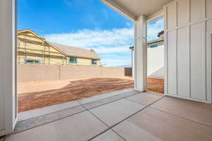 Fenced backyard with a patio area