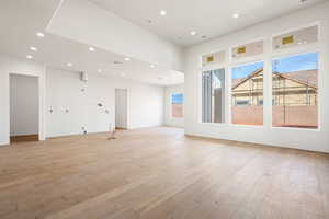 Unfurnished room with light wood finished floors and recessed lighting